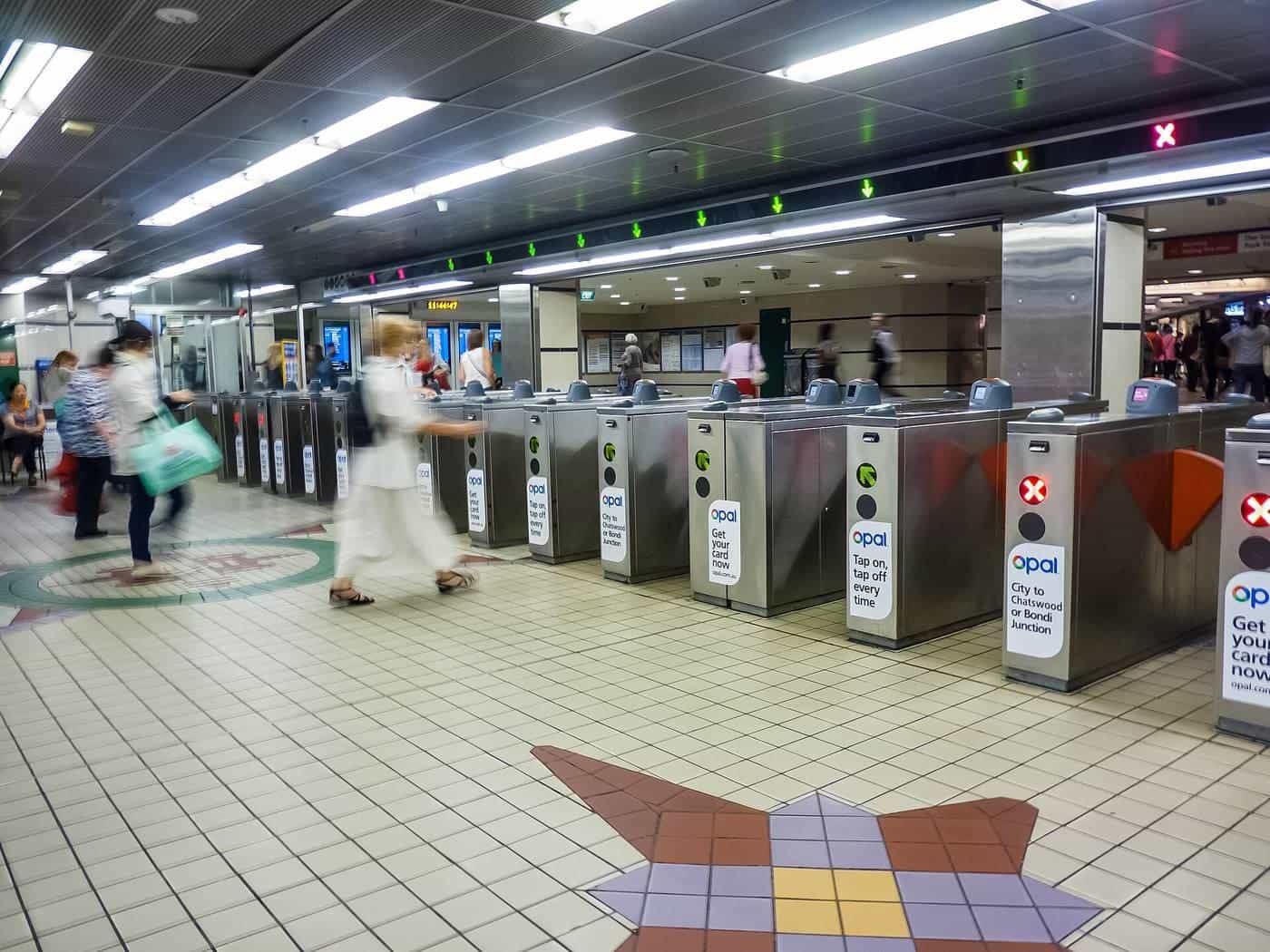 Ticket gates and commuters at a busy railway station concourse in Sydney