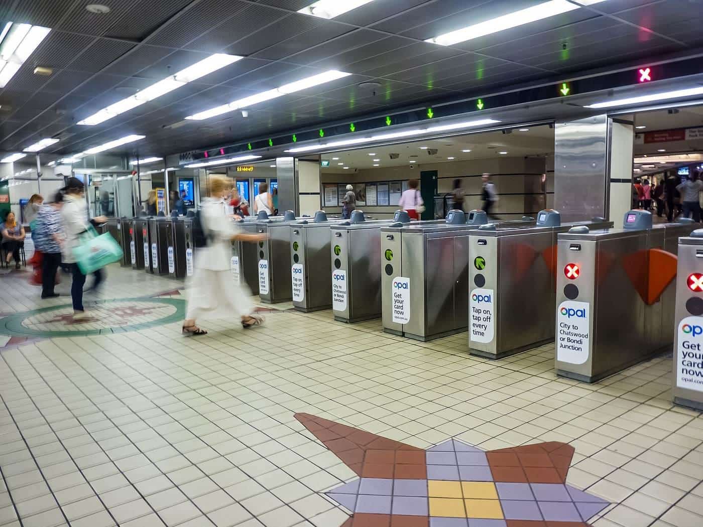 Ticket gates and commuters at a busy railway station concourse in Sydney